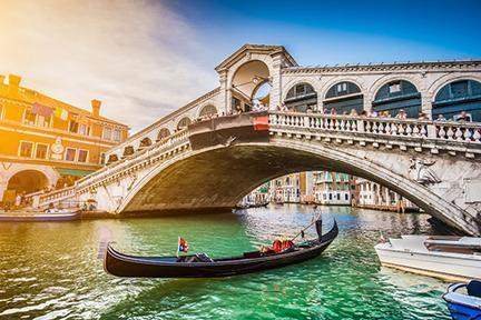 Góndola transitando por debajo del famoso puente Rialto de Venecia